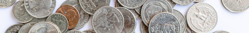  A pile of US coins sitting on a white table