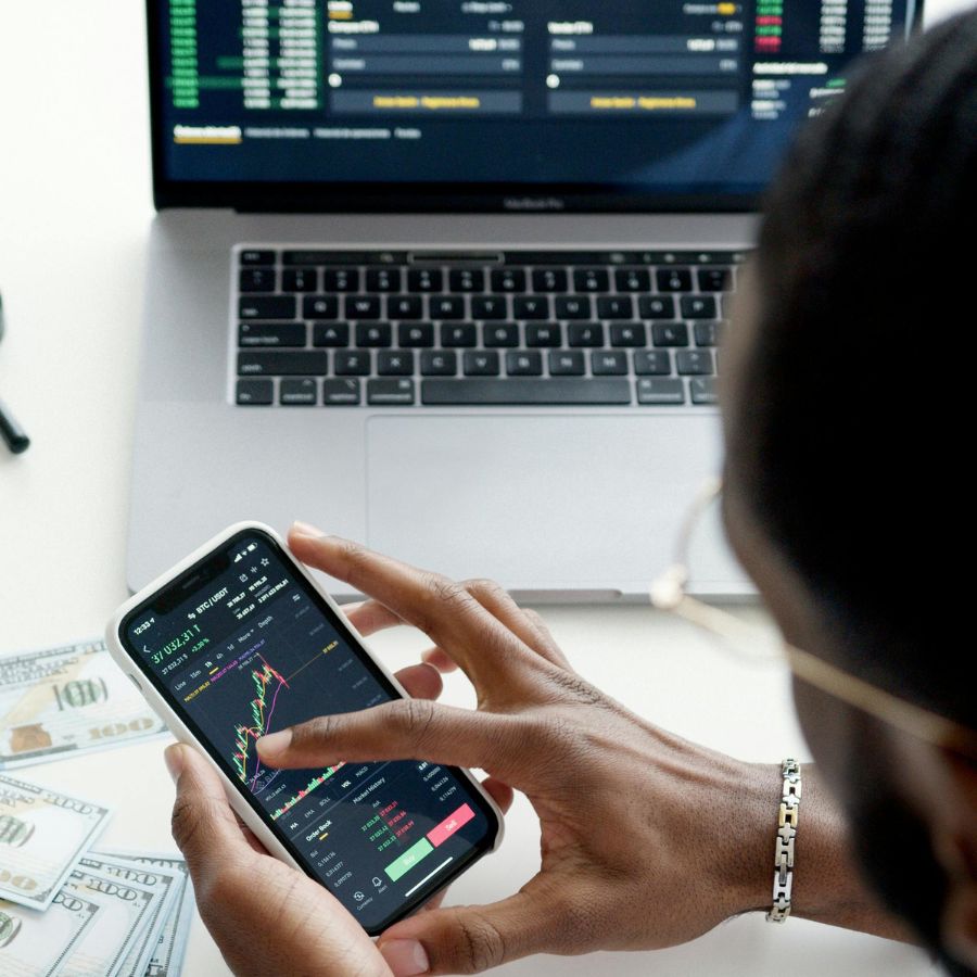 A man tracks investments from his cell phone