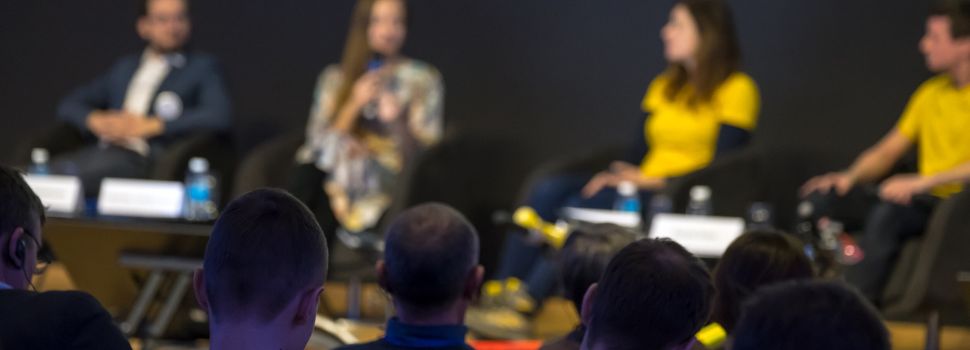 A panel speaking at a coin convention